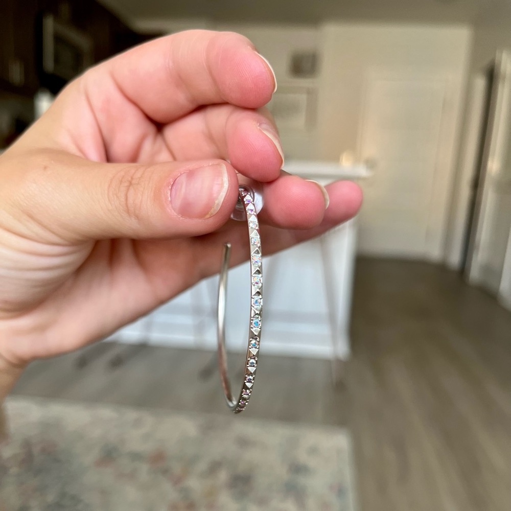Kendra Scott silver hoop earrings.